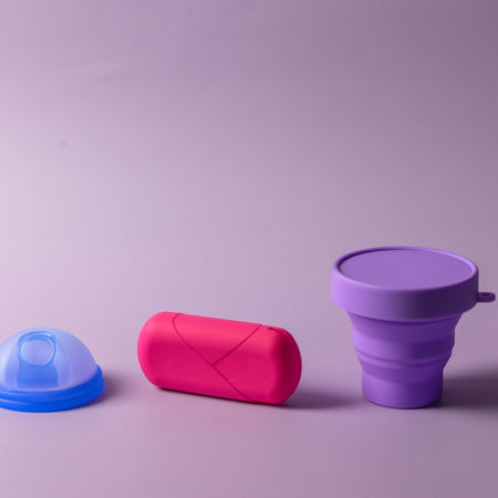 Bohokiwi Ocean Blue menstrual disc with Pink capsule carrier case and Purple collapsible steriliser