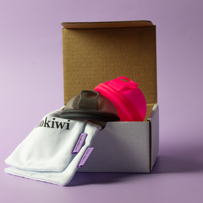Bohokiwi Neon Pink and Midnight Black menstrual discs with cotton storage bags and box
