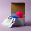 Bohokiwi Ocean Blue and Neon Pink menstrual discs with cotton storage bags and box 