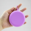 Bohokiwi Purple round menstrual disc carrier case held in hand