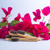 bohokiwi bamboo cleaning brushes displayed with bright pink flowers