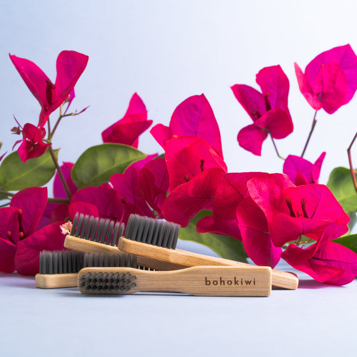 bohokiwi bamboo cleaning brushes displayed with bright pink flowers