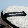 Close-up of soft reusable makeup remover pad with bohokiwi finger strap