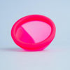 Close-up of Bohokiwi Neon Pink menstrual disc showing the flexible basin and rim